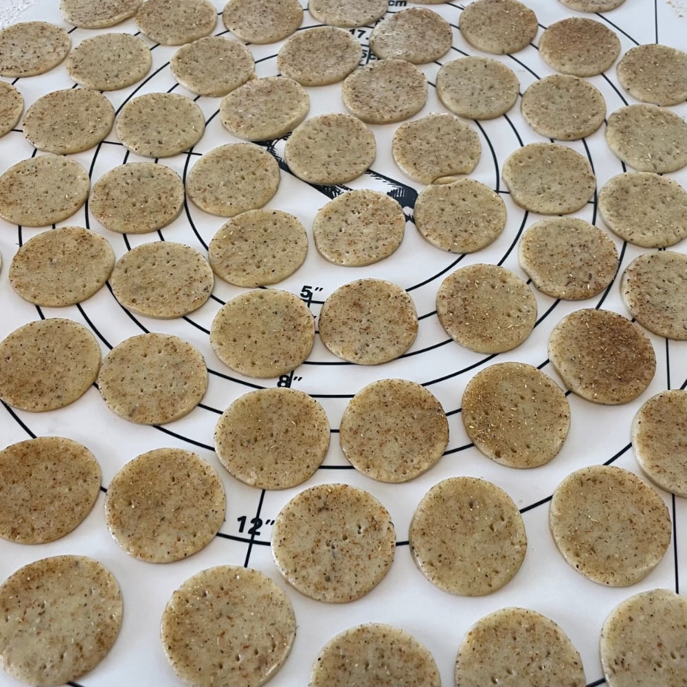 Butter crackers with mushroom butter cut into circles using a small round cookie cutter 